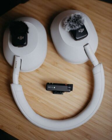 White headphones with two small microphones and transmitter.