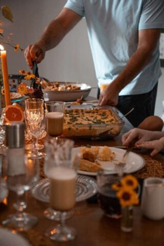 Photo by Cocodillaa.com a group of people standing around a table with food