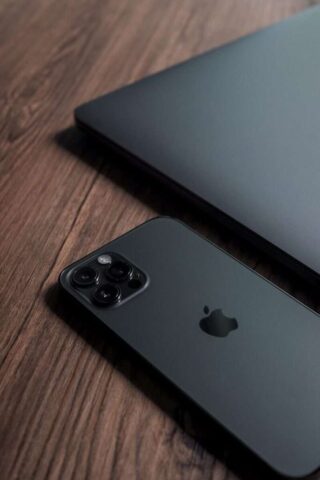 silver macbook on brown wooden table