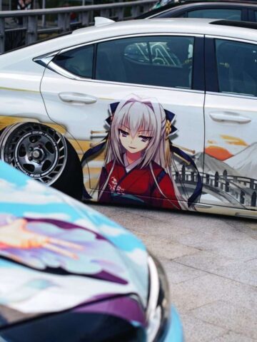A car painted with anime characters on it