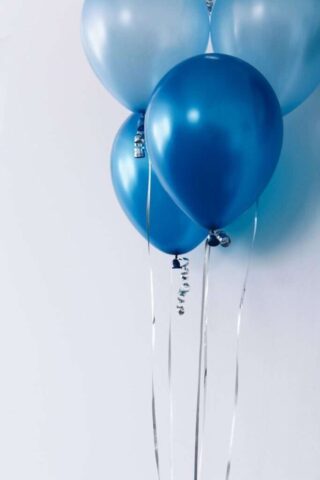 Photo by Cocodillaa.com four blue balloons near white wall