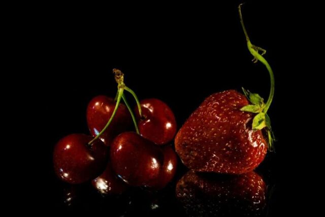 a group of cherries sitting on top of a table