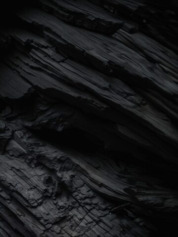 A close up of a cell phone on a wooden surface