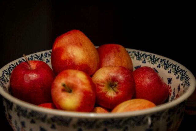 A bowl of red and yellow apples