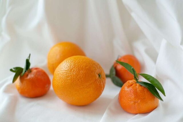 orange fruit on white textile