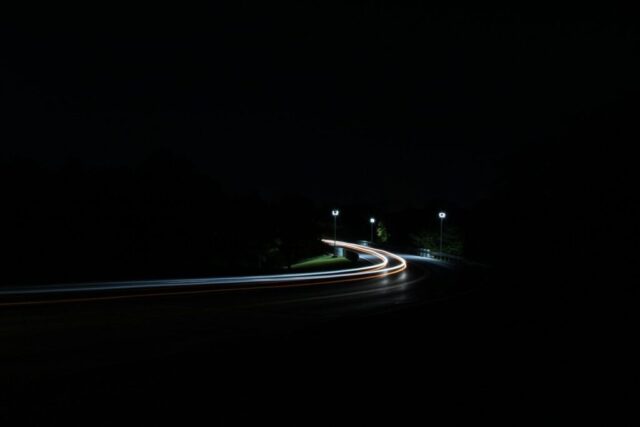 time-lapse photography of moving vehicles on road