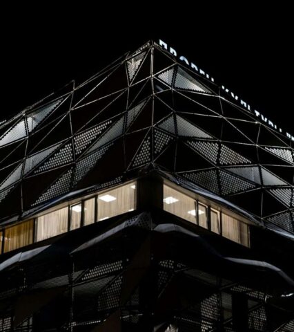 Modern geometric building illuminated at night