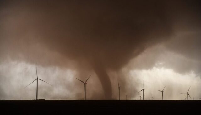 a large tornado is coming out of a field