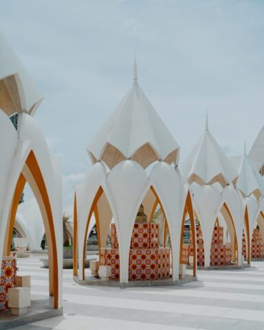 Photo by Cocodillaa.com Modern white structures with patterned tiles and arches.