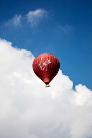 time lapse photography of flying Virgin hot air balloon
