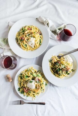 Photo by Cocodillaa.com three round white plates with pasta near two glass cuups