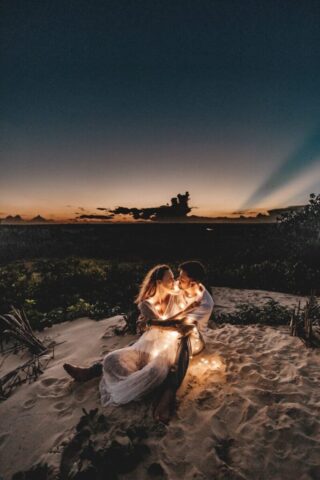 Photo by Cocodillaa.com man and woman looking each other sitting on white sand during sunset
