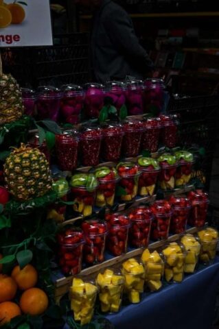 A fruit stand with many different types of fruit