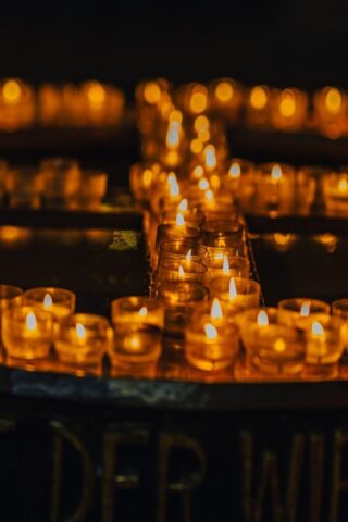 Photo by Cocodillaa.com rows of lit candles sitting on top of a table
