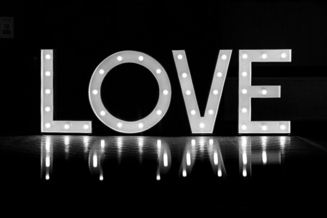 Photo by Cocodillaa.com the word love is lit up in the dark