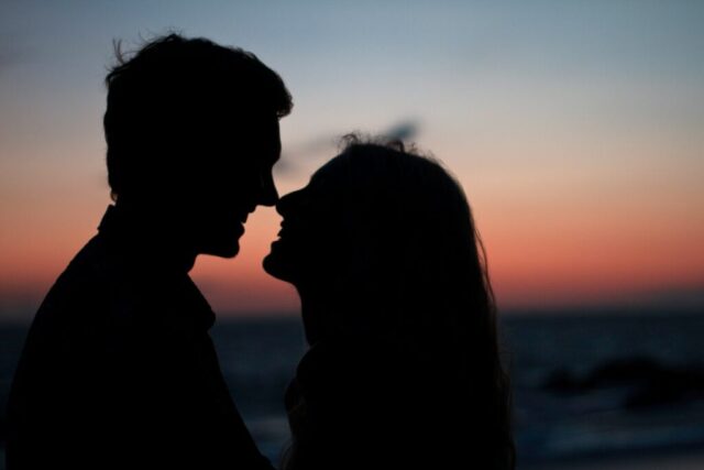 Photo by Cocodillaa.com silhouette of man and woman about to kiss on beach during sunset