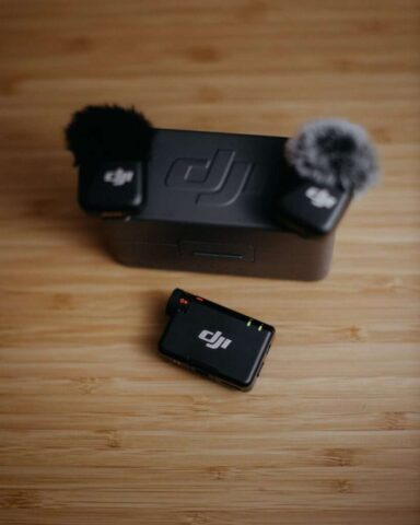 Two dji wireless microphones and charging case