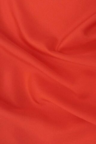 red textile on brown wooden table