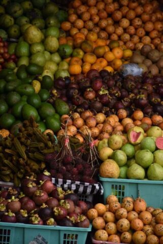a large display of fruits and vegetables in baskets