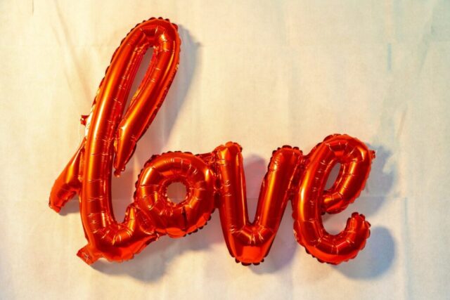Photo by Cocodillaa.com the word love spelled out of balloons on a sheet of paper