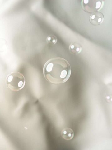 Photo by Cocodillaa.com Bubbles float against a white, silky background.