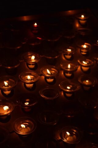 Photo by Cocodillaa.com A group of lit candles sitting on top of a table