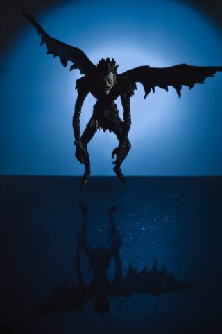 A silhouette of a demon on a dark blue background