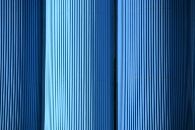 Photo by Cocodillaa.com a close up of a row of blue pipes