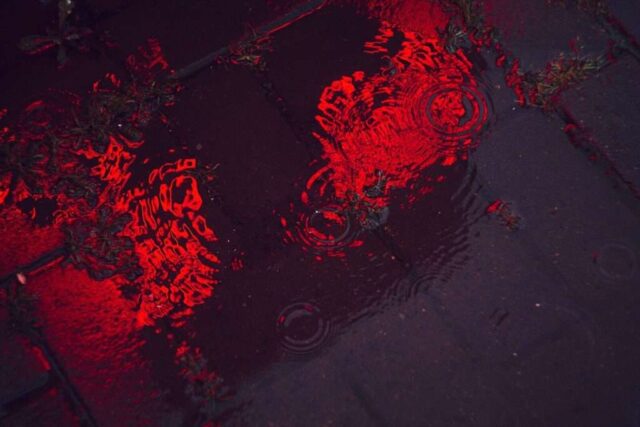 a reflection of a bike in a puddle of water