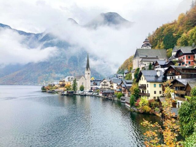 a town next to a body of water with Hallstatt in the background