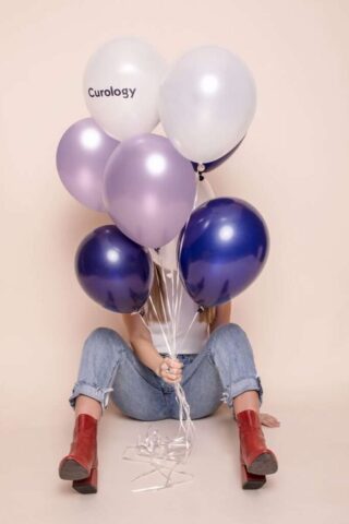 Photo by Cocodillaa.com woman holding six assorted-color balloons