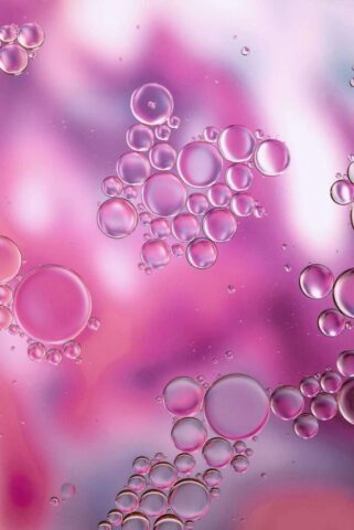 Photo by Cocodillaa.com a close up of bubbles on a purple and pink background