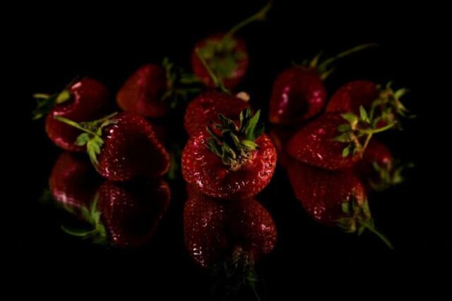 a group of strawberries sitting on top of a table
