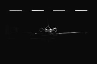 Photo by Osman Rana white jet plane in warehouse