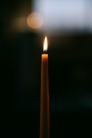 Photo by Cocodillaa.com A single candle is lit in the dark