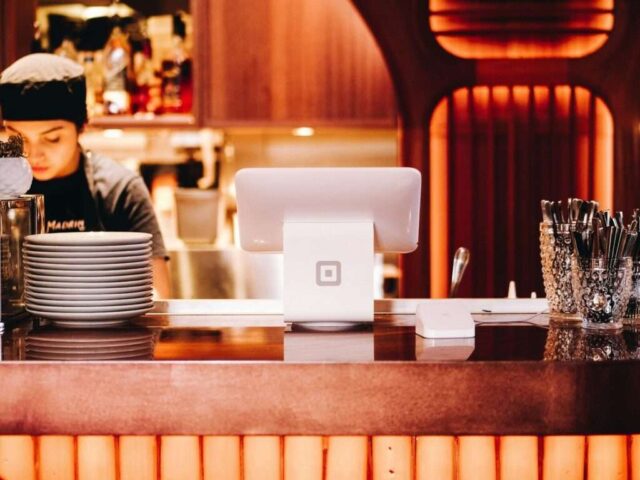 Photo by Cocodillaa.com woman in black crew-neck t-shirt standing near counter