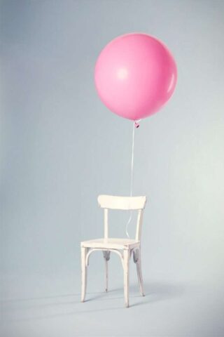 Photo by Florian Klauer pink balloon tied on white wooden chair