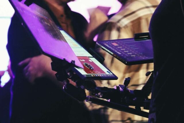 Person holding a tablet with a red card displayed