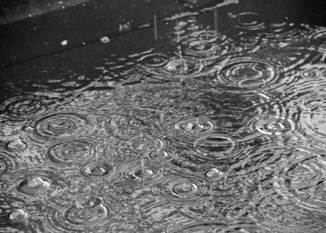 Photo by Cocodillaa.com a black and white photo of raindrops in a puddle