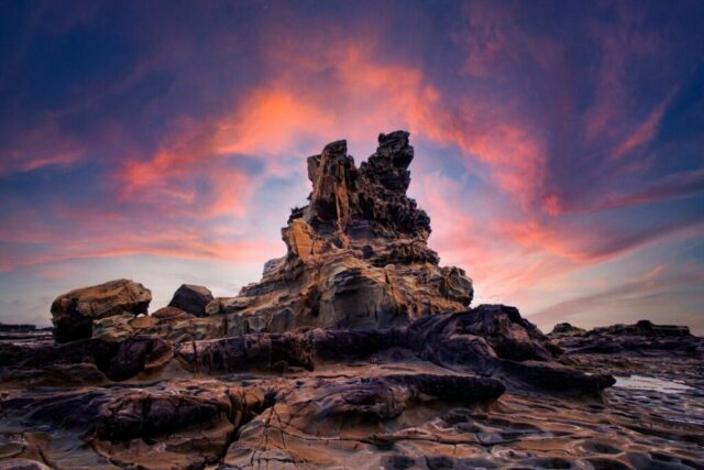Photo by Cocodillaa.com brown rock formation under orange and blue sky