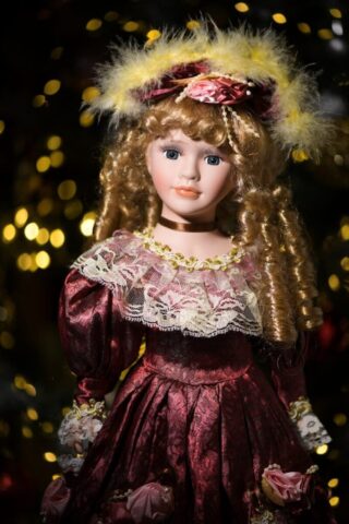 A close up of a doll wearing a red dress