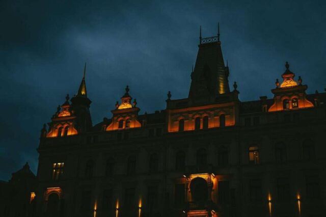a large building with a clock tower lit up at night