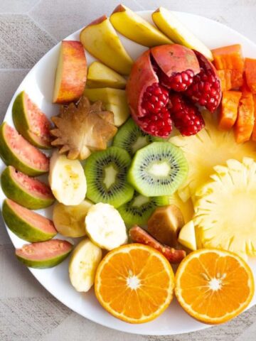 a white plate topped with cut up fruit