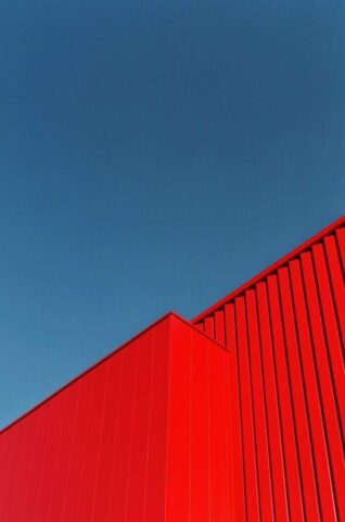 a red building with a blue sky in the background