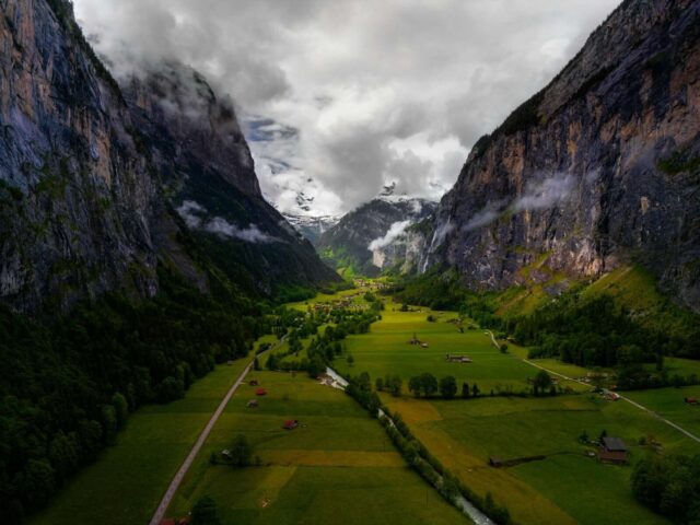 An aerial view of a valley with mountains in the background