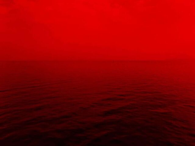 photo of ocean with red lights