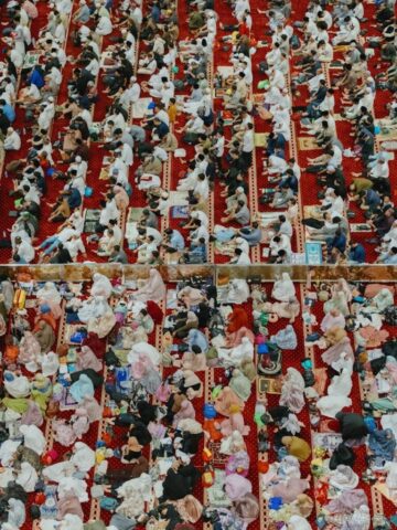 Photo by Cocodillaa.com Worshipers kneel on red carpets in a mosque.