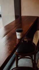 Photo by Cocodillaa.com a cup of coffee sitting on top of a wooden table