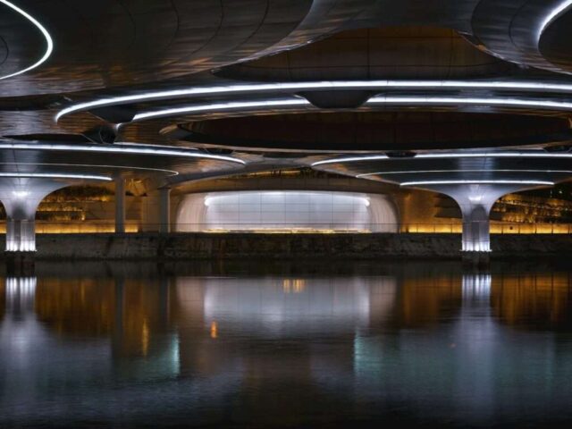 Modern architecture with illuminated circular elements over water