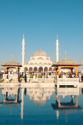 Photo by Cocodillaa.com A group of people standing in front of a large building